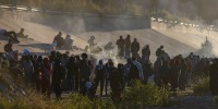 Smoke rises from small fires keeping migrants warm as they wait to cross the Mexico-U.S. border from Ciudad Juarez, Mexico on Dec. 12, 2022. 