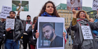 Demonstrators gather at the Brandenburg Gate in Berlin to protest the arrest of Iranian rapper Toomaj Salehi on Nov. 4, 2022.