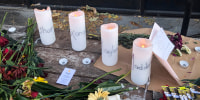 Candles and flowers are left at a make-shift memorial honoring four slain University of Idaho students in downtown Moscow, Idaho, on Nov. 15, 2022.