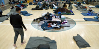 Migrants rest at a makeshift shelter in Denver on Friday, Jan. 6, 2023. Over the past month, nearly 4,000 immigrants, almost all Venezuelans, have arrived unannounced in the frigid city, with nowhere to stay and sometimes wearing T-shirts and flip-flops. In response, Denver converted three recreation centers into emergency shelters for migrants and paid for families with children to stay at hotels, allocating $3 million to deal with the influx.