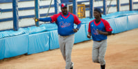 Batting coach Pedro Luis Lazo, left, and pitcher Livan Moinelo warm up as Cuban national baseball team hopefuls begin training for the 2023 World Baseball Classic