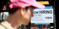 A "Now Hiring" sign is displayed on a shopfront on Aug. 5, 2022 in New York City. 