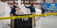 FBI special agents process material recovered from the high altitude balloon at the FBI laboratory