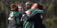 People leave flowers, mourn and pray at a makeshift memorial at the Spartan statue on the campus Michigan State University on Feb. 14, 2023 in East Lansing, Mich.
