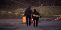Suffolk County crime investigators approach a crashed plane Sunday near Babylon, N.Y.