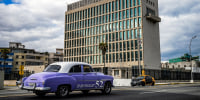An old American car passes by the U.S. embassy in Havana on May 3, 2022.