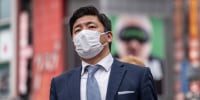 Japan's government eased its mask guidelines on March 13, recommending them only on crowded trains and in hospitals or care homes, but there was little sign residents were keen to unmask.
