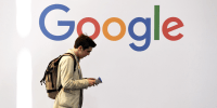 A man walks past the Google logo during the VivaTech trade fair in Paris,