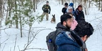 A U.S. Border Patrol agent apprehends seven Mexican citizens near Mooers, N.Y., who had crossed into the U.S. from Canada illegally 