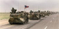 A convoy of U.S. Army tanks driving down the road from Kuwait towards Dhahran in the Saudi desert as U.S. troops begin their withdrawal from Kuwait on March 5, 1991.