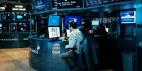 A trader works at a computer on the floor of the New York Stock Exchange
