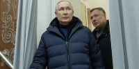 In this photo taken from video released by Russian TV Pool on Sunday, March 19, 2023, Russian President Vladimir Putin escorting by Russian Deputy Prime Minister Marat Khusnullin visits the Mariupol theater during his visit to Mariupol in Russian-controlled Donetsk region, Ukraine. Putin has traveled to Crimea to mark the ninth anniversary of the Black Sea peninsula's annexation from Ukraine (Pool Photo via AP)