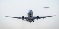 Image: A plane takes off as another comes in for a landing from Ronald Reagan Washington National Airport in Arlington, Va., on March 20, 2023.