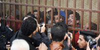 Men accused of "debauchery" are held behind bars in a court in Cairo