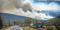 A flare up near Cleveland, just down 519 from Mora, N.M. darkens the sky on Wednesday, May 4, 2022, where firefighters have been battling the Hermit's Peak and Calf Canyon fire for weeks. Weather conditions described as potentially historic are on tap for New Mexico on Saturday, May 7, and over the next several days as the largest fire burning in the U.S. chews through more tinder-dry mountainsides.
