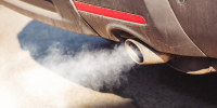 A car exhaust emits fumes.