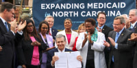 Gov. Roy Cooper signs a Medicaid expansion law in Raleigh, N.C., on  March 27, 2023.