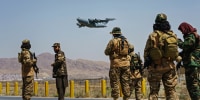 Taliban fighters secure the outer perimeter of the Hamid Karzai International Airport