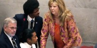 Rep. Justin Jones, D-Nashville, center, Rep. Justin Pearson, D-Memphis, back left and Rep. Gloria Johnson, D-Knoxville, huddle on the floor of the House chamber Thursday, April 6, 2023, in Nashville, Tenn. Tennessee Republicans are seeking to oust the three House Democrats for using a bullhorn to shout support for pro-gun control protesters in the House chamber. (AP Photo/George Walker IV)