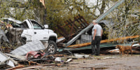 A man surveys the debris outside his destroyed home on April 5, 2023 in Glenallen, Mo.