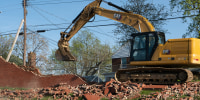 Construction workers demolish the "Spite Wall" at Morgan State University in Baltimore