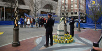 Families of the victims of the marathon bombing gather at a memorial