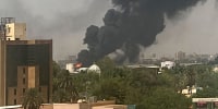 Smoke billows above residential buildings in Khartoum