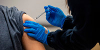 A man receives a Pfizer-BioNTech Covid-19 vaccine in Chelsea, Mass