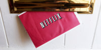A Netflix Inc. envelope is arranged for a photograph in the Queens borough of New York, U.S, on Friday, Nov. 7, 2003. Netflix Inc. shares are almost eight times more expensive than those of the three largest home-video rental chains, Blockbuster Inc., Movie Gallery Inc. and Hollywood Entertainment Corp., base on profit estimates for this year. 