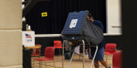 A person casts their ballot at an early voting polling location in Houston