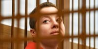 Yevgenia Berkovich sits in a cell at court in Moscow