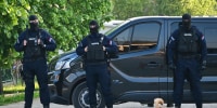 Masked police secure an area in the village of Dubona near the town of Mladenovac, on May 5, 2023, in the aftermath of a deadly drive-by shooting. 