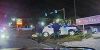 Police surround Tyrea Pryor in a crashed car in Independence, Mo., in March 2022.