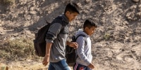 Guatemalan migrants walk along the U.S. side of the Rio Grande after crossing over from Mexico on May 13, 2023, to El Paso, Texas. 