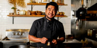 Chef Aaron Verzosa demonstrates plating Tailor Made, a course in which diners disclose their hunger level from five to one, at Filipino American restaurant Archipelago on May 24, 2023, in Seattle.