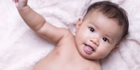Portrait of a baby with soft blanket color background
