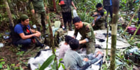 In this handout photo released on June 9, 2023, by the Colombian Presidency, members of the army assist four Indigenous children who were found alive after spending more than a month lost in the Colombian Amazon jungle following the crash of a small plane. Four Indigenous children were found alive Friday after spending more than a month lost in the Colombian Amazon rainforest following a small plane crash that triggered a massive rescue operation, the country's President Gustavo Petro said. 