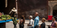 People stand in line to buy food, in Havana, on March 31, 2023.