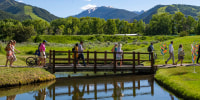 Attendees end their day on the Aspen Institute campus with a stroll through the meadow at Aspen Ideas Festival in Aspen, Colo. on Tuesday, June 27, 2023.