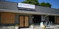Windows are boarded up at Clearway Clinic, where vandals smashed windows with a hammer on July 7, 2022.