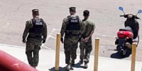 Police take a Marine into custody on June 28, 2023, at Camp Pendleton in Oceanside, Calif., in connection with a teen who was missing for 15 days.