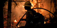 A Forest Service firefighter works the Caldor Fire in El Dorado County, Calif., on Aug. 28, 2021.