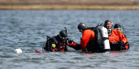 Suffolk County dive team police officers search for possible victims of a suspected serial killer in Hemlock Cove along Ocean Parkway near Cedar Beach, N.Y., April 14, 2011. A Long Island architect has been charged, Friday, July 14, 2023, with murder in the deaths of three of the 11 victims in a long-unsolved string of killings known as the Gilgo Beach murders.