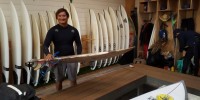 This May 19, 2019, photo provided by Dr. John Jones shows Mikala Jones at Surf Ranch in Lemoore, California, holding a surfboard his brother made using material from the agave plant.