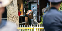 Crime laboratory officers removes boxes as law enforcement searches the home of Rex Heuermann