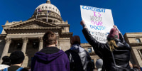 People gather at the state Capitol to oppose anti-transgender legislation