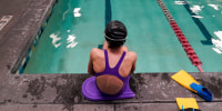 A 12-year-old trans swimmer waits by a pool in Utah on Feb. 22, 2021.