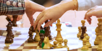 People move pieces during the FIDE Chess World Rapid Blitz