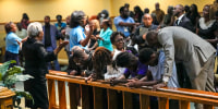Image: Church members at the St. Paul A.M.E. Church pray with four Edward Waters University students, center, that attended a prayer service for the victims of a mass shooting, on Aug. 27, 2023, in Jacksonville, Fla.