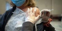 A woman receives a Covid-19 booster shot at a vaccine clinic in Lansdale, Pa.